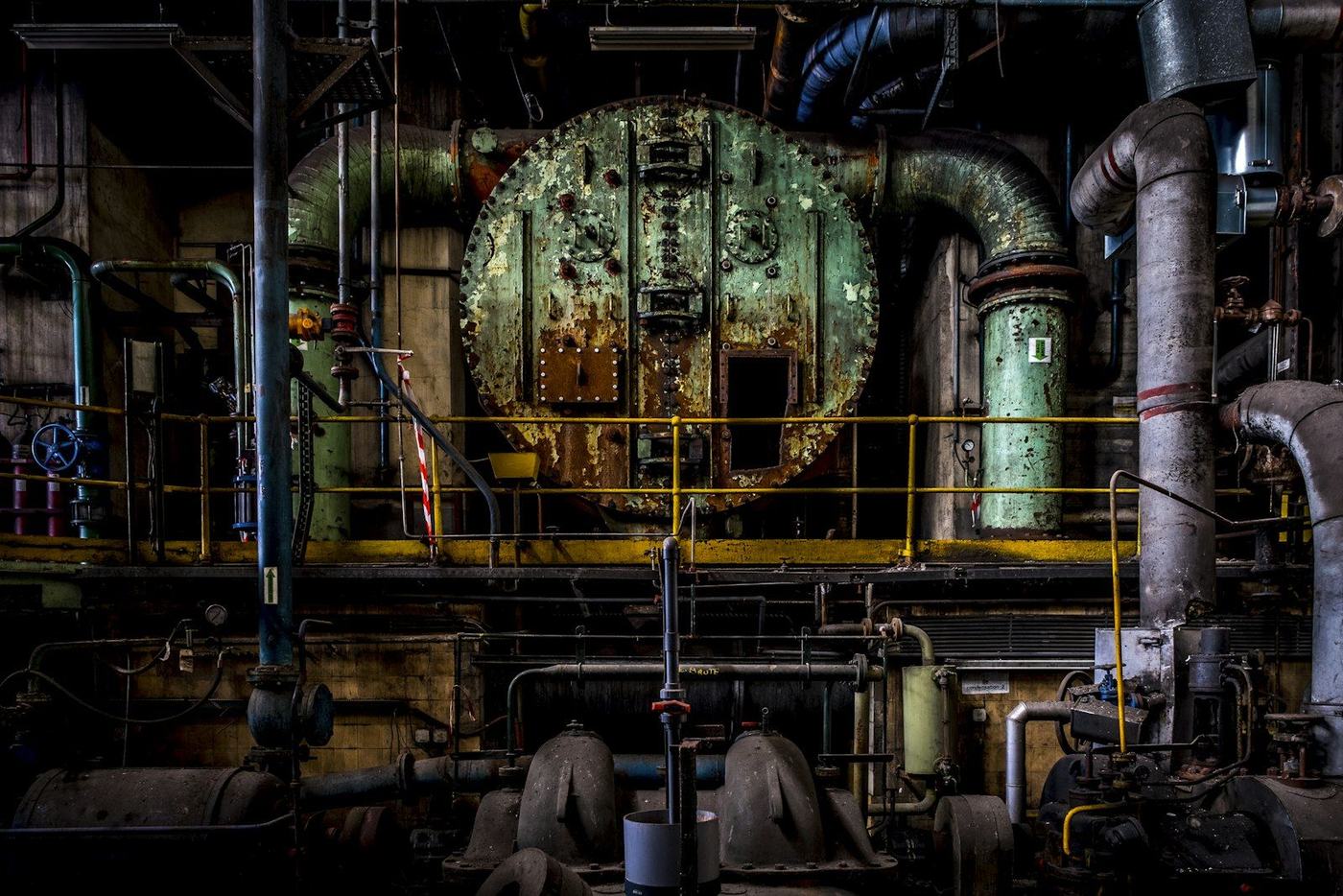 Industrial plant machinery, pipework and pressure vessels inside a factory